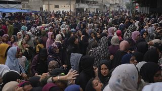 Palestinian children line up in Gaza Strip hoping to be distributed a warm meal